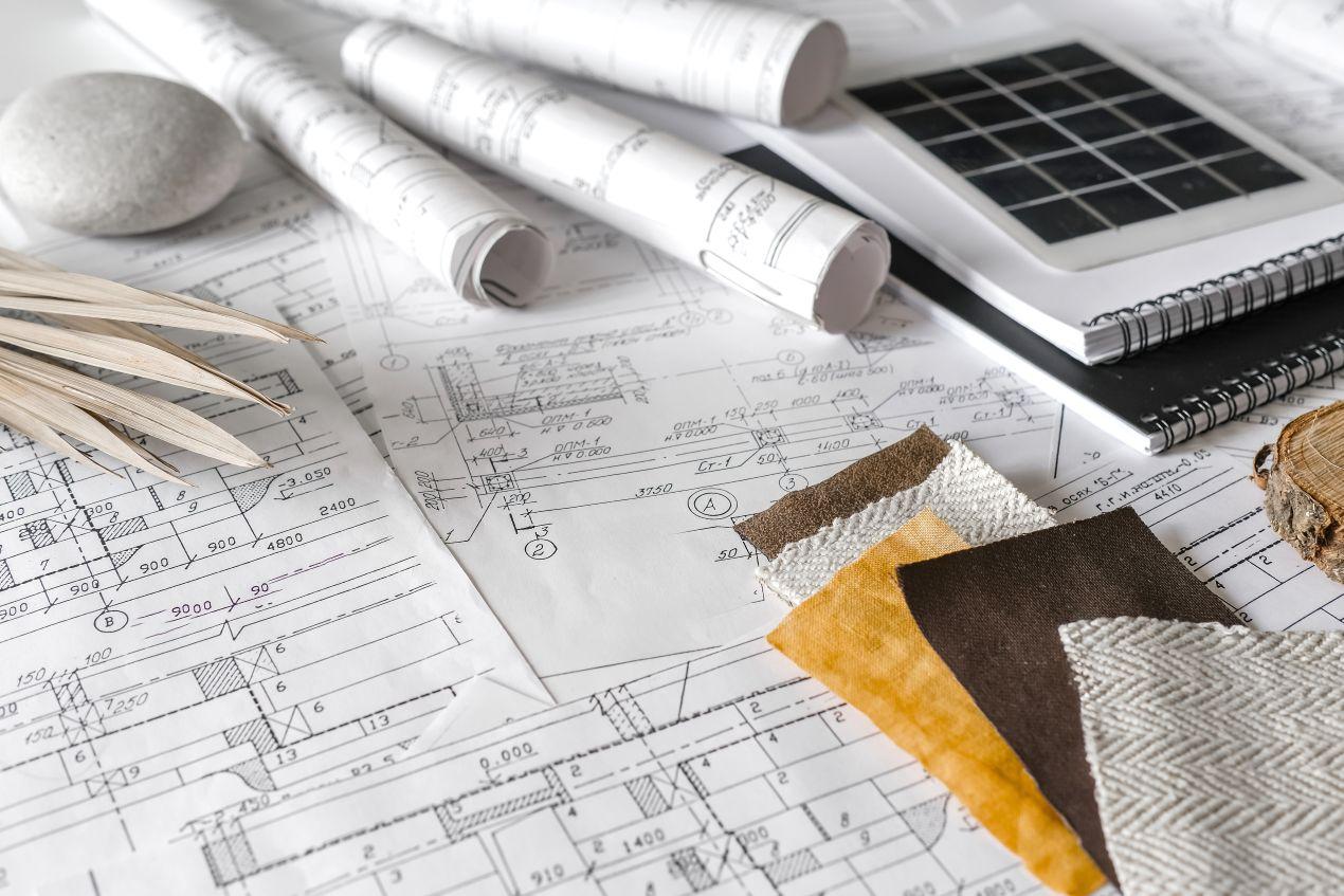 Architekturpläne mit Stoffmustern und Materialien für nachhaltige Bauplanung mit Gründach Konzept